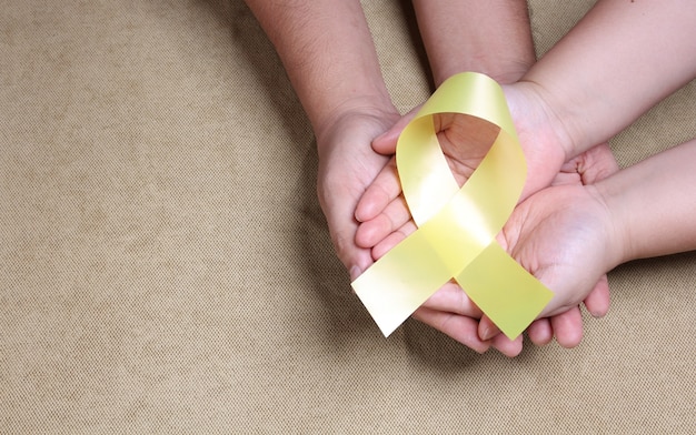 hands holding yellow ribbon With copy space.