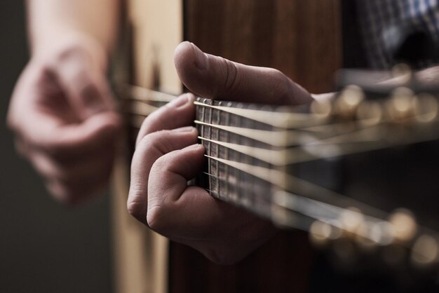 Hands home and man with guitar creative and instrument with performance talent and musician Learning closeup and person with audio solo artist or strumming with culture production and strings