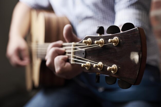 Hands home and man with guitar music and instrument with strings talent and musician Learning closeup and person with audio producing sound or strumming with creativity culture and practice