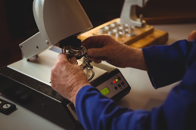 Hands of horologist repairing a watch