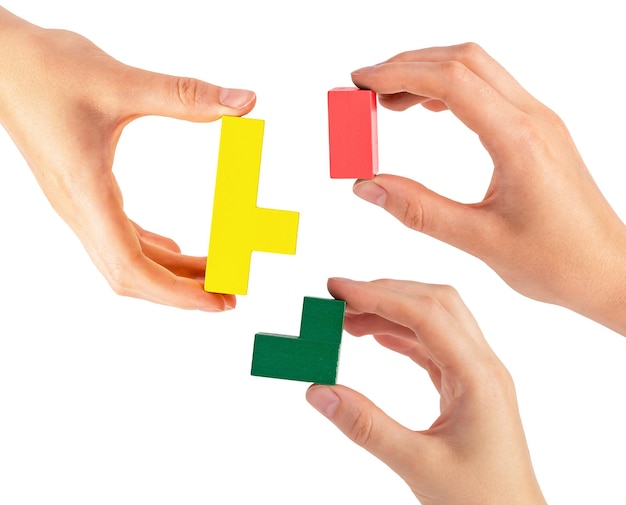 Hands joining puzzle pieces isolated on white background Teamwork partnership concept Help and support among colleagues teambuilding