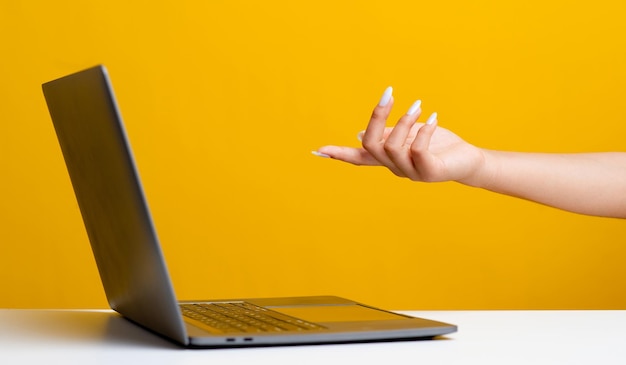 Hands and laptops manual commands let the computer work commanding the computer operating system by hand