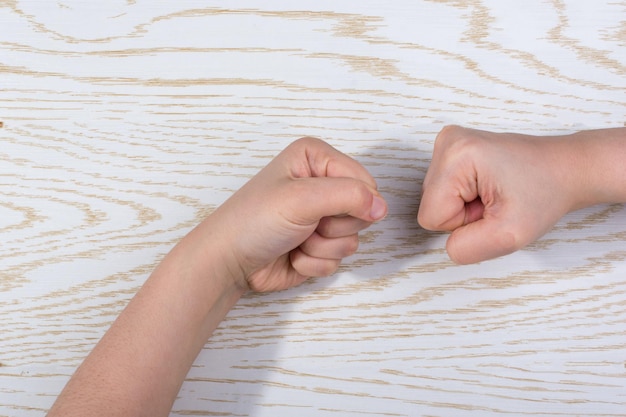 Hands making a gesture on wooden background