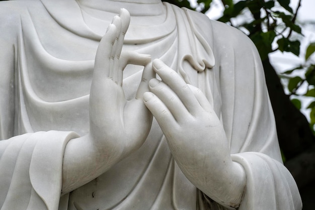 Hands marble Buddha statues in a Buddhist temple in the city of Danang Vietnam Closeup