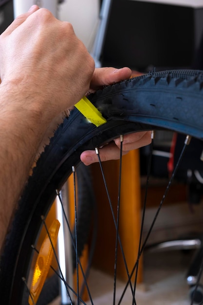 Hands of a mechanic adjusting the wheel of a bicycle