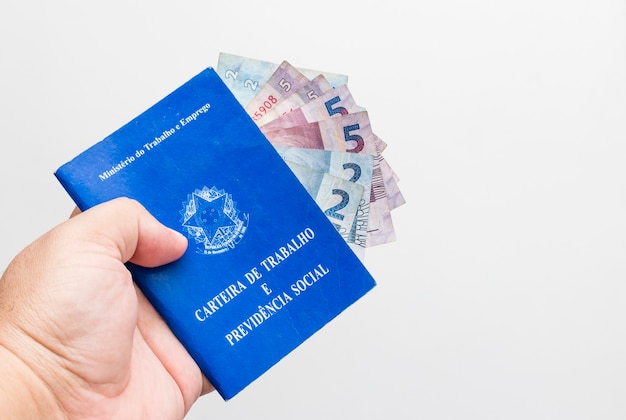 Hands of middle-aged man holding work book, Brazilian social security document