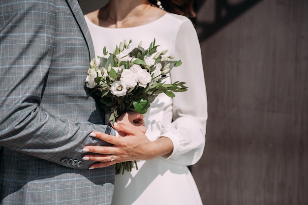 The hands of the newlyweds gently touch each other 3823