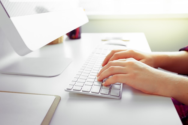 Hands of an office woman typing