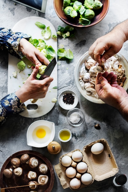 Hands prepare raw food for cooking