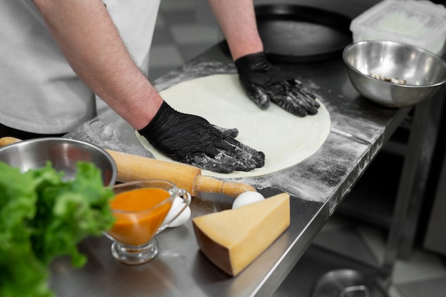 hands preparing pizza dough