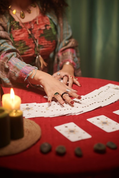 Hands of psychic reading tarot cards seeing fortune