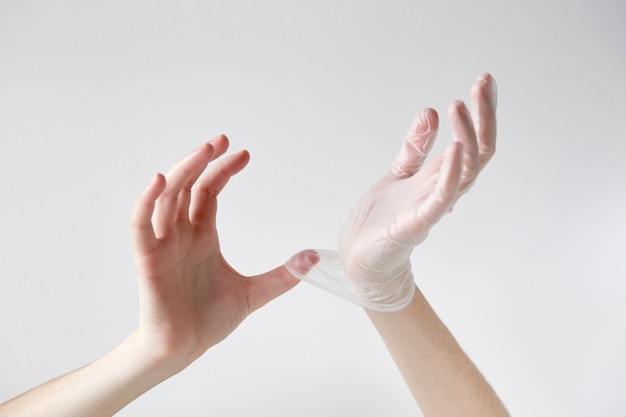 Hands putting on plastic gloves