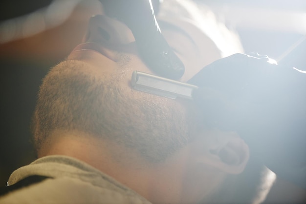 Hands shave the beard men barbershop razor closeup