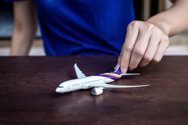 Hands support airplane model