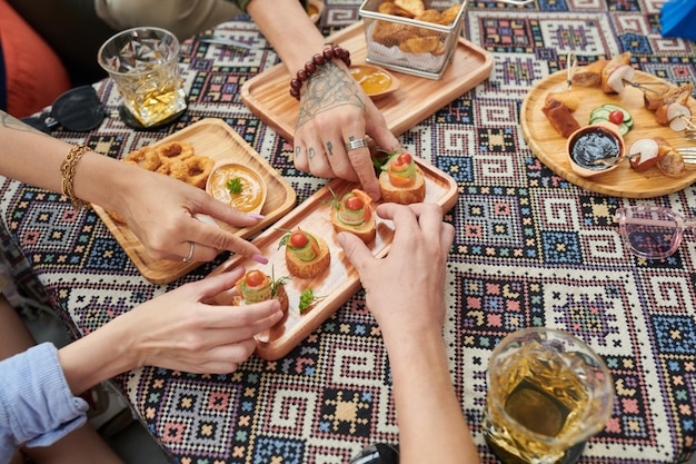 Hands Taking Snacks from Plate