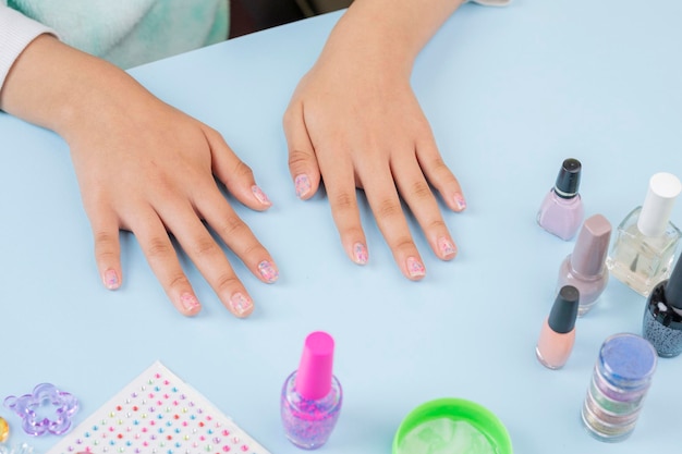 Hands of a teenage woman who has just painted her nails at home