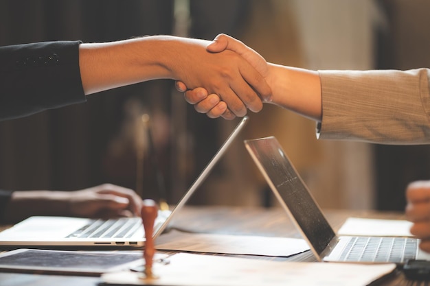 Hands of two male business people shaking hands and sealing a partnership