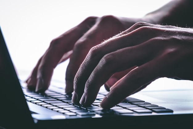 Hands typing on the computer keyboard. Modern style