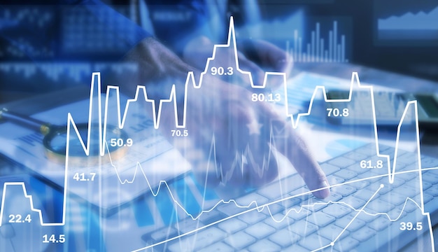 Hands typing the keyboard Graphs and charts Internet trading and management