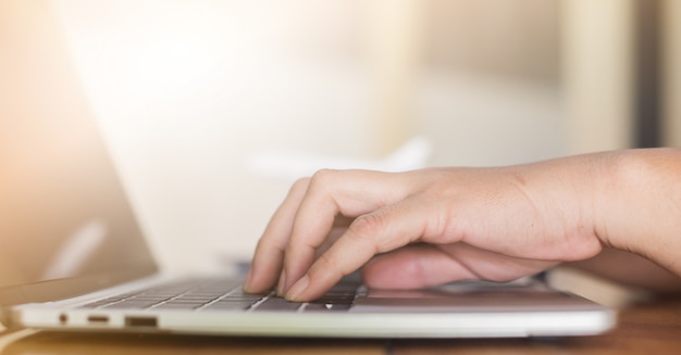 Hands typing on a laptop keyboard