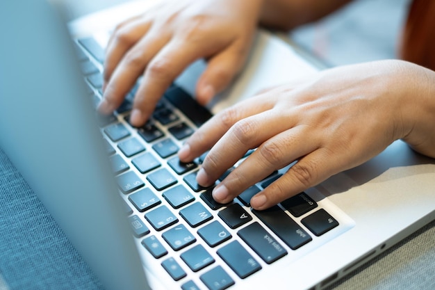 Hands typing on a notebook keyboard. selective, soft focus