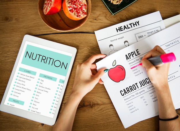 Hands underlying text on a nutrition paper