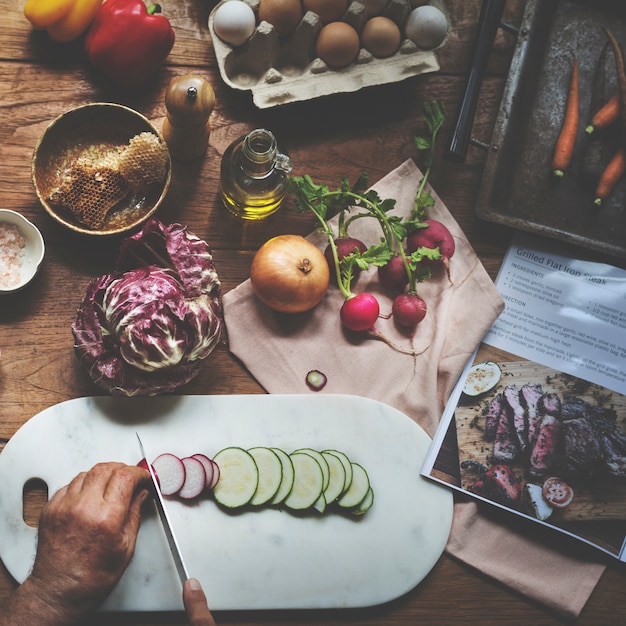 Hands using knife chopping a zucchini