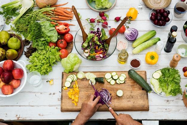 Hands using knife cutting a red cabbage