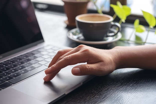 Hands using and touching on laptop touchpad