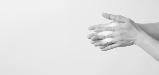 Hands washing gesture with foaming hand soap on white background