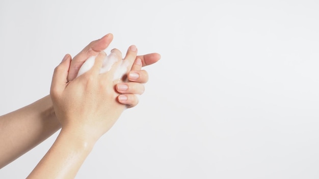 Hands washing gesture with foaming hand soap on white background