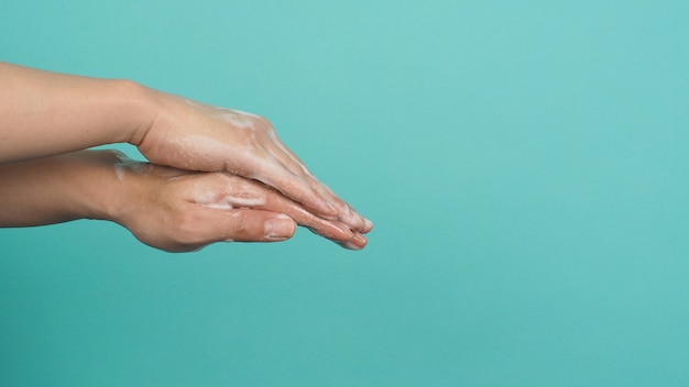 Hands washing gesture with foaming hand soap