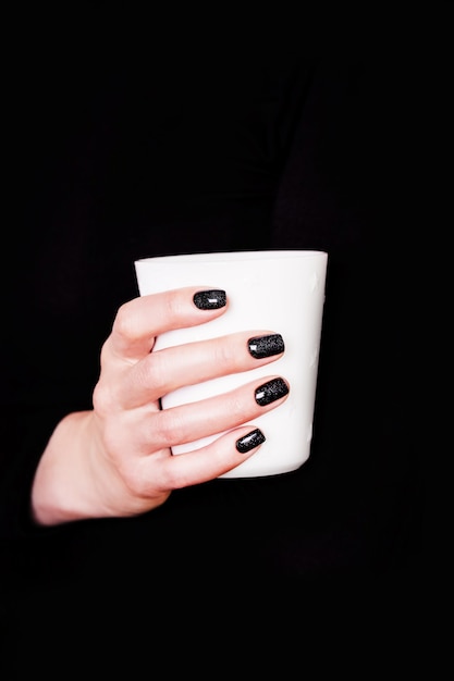 Hands and white cup