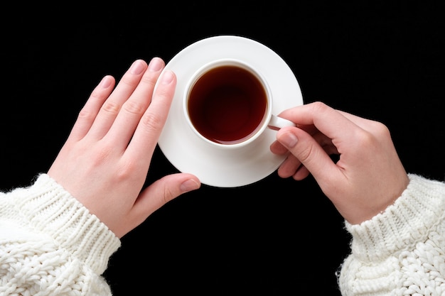 hands with a cup of coffee