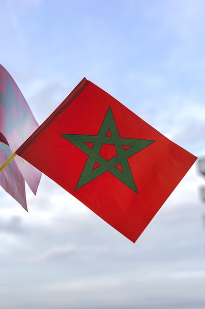 Hands with flags of Morocco with defocused background