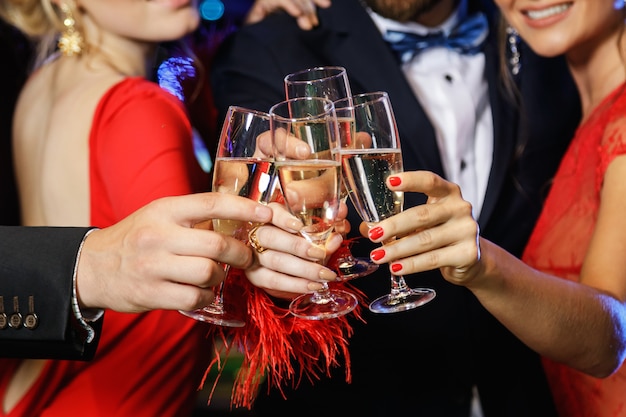 Hands with a full glasses of sparkling wine