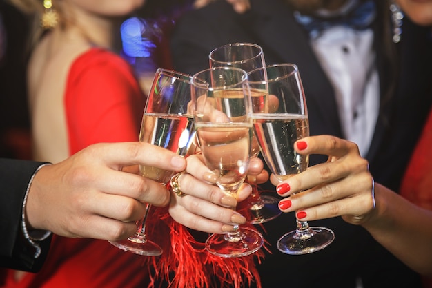 Hands with a full glasses of sparkling wine