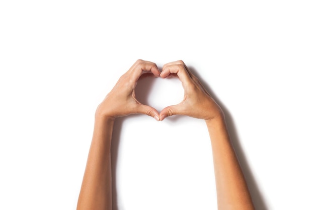 Photo hands with heart shape on white background with shadow