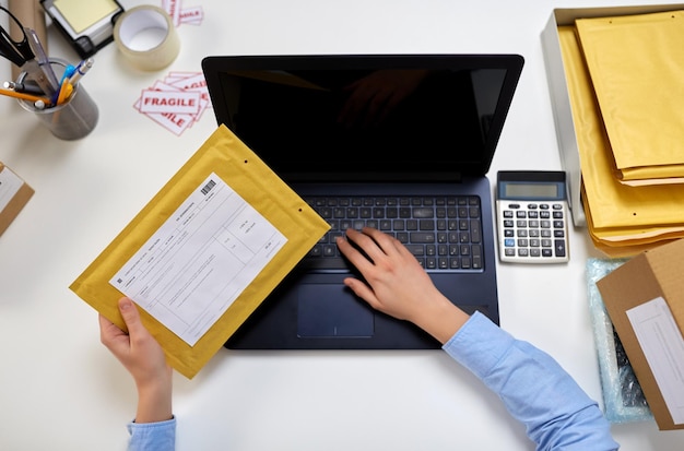 Photo hands with laptop and envelope at post office