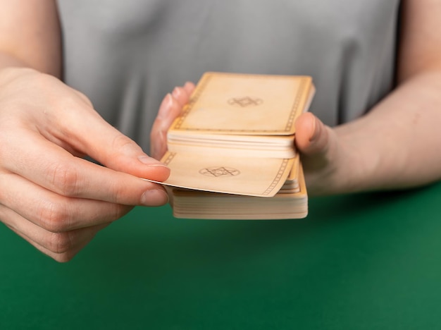 Hands with tarot cards dividing deck into two parts for divination choosing taro for reading telling future