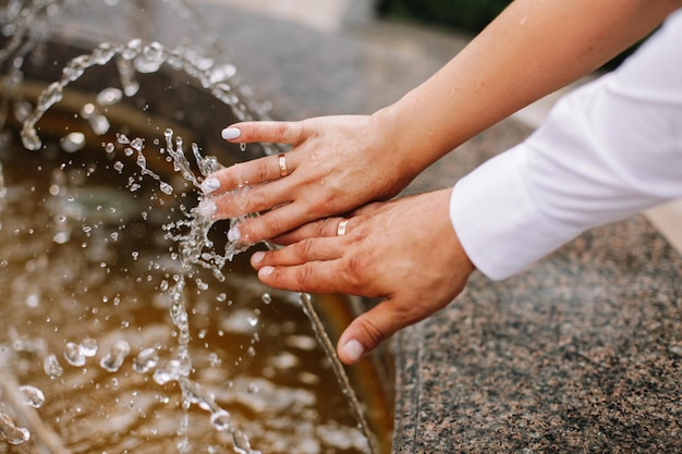 Hands with water splash backlit by the evening sun