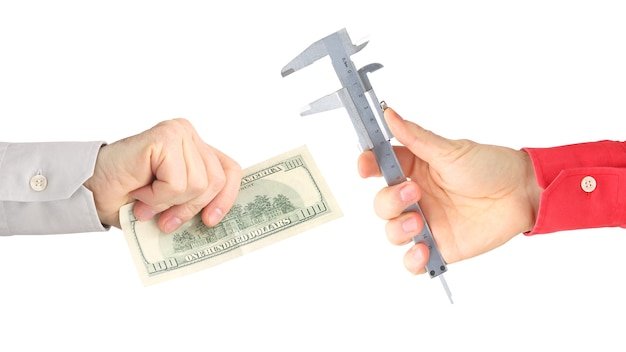 Hands with work tool and money on a white background. salary. business relationship.