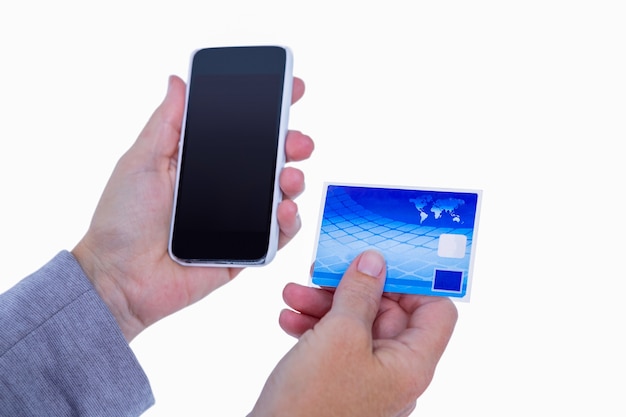 Hands of woman holding smartphone and credit card