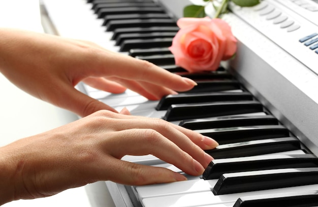 Hands of woman playing synthesizer