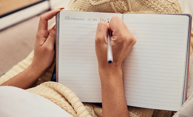 Photo hands of woman relax writing in notebook mockup for morning routine on living room sofa affirmations personal goals and book of calm life thoughts or young girl creative thinking journal on couch