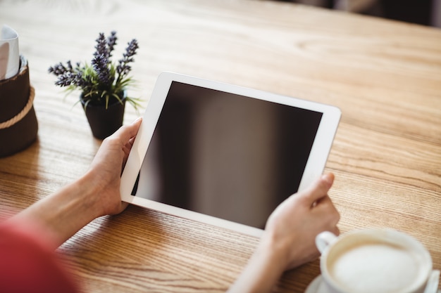 Hands of woman using digital tablet