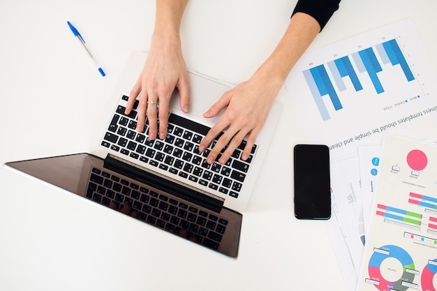 Hands of a woman using a laptop