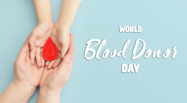 Hands women hold drop of blood Concept of give blood donation blood transfusion