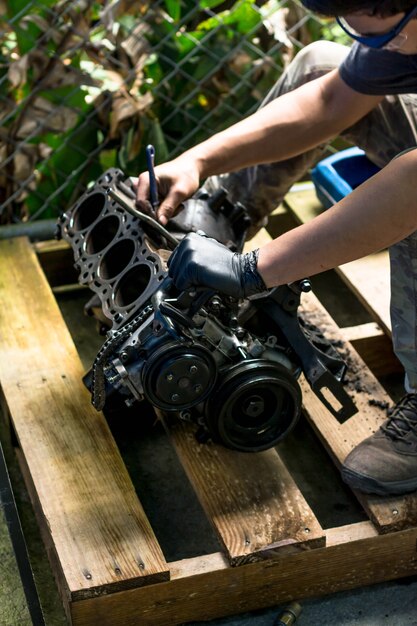 Hands working in a car engine. Cleaning a Car engine. Mechanical Workshop