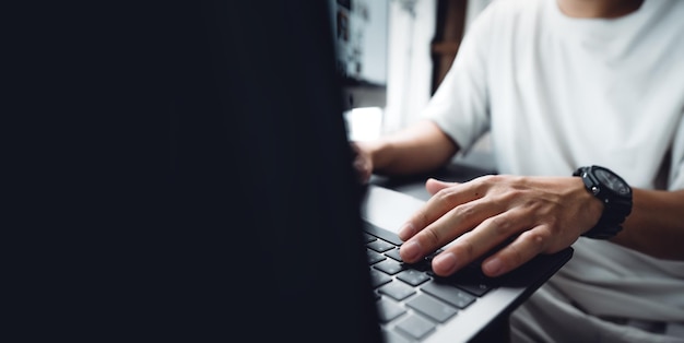 Hands working on a laptop computer